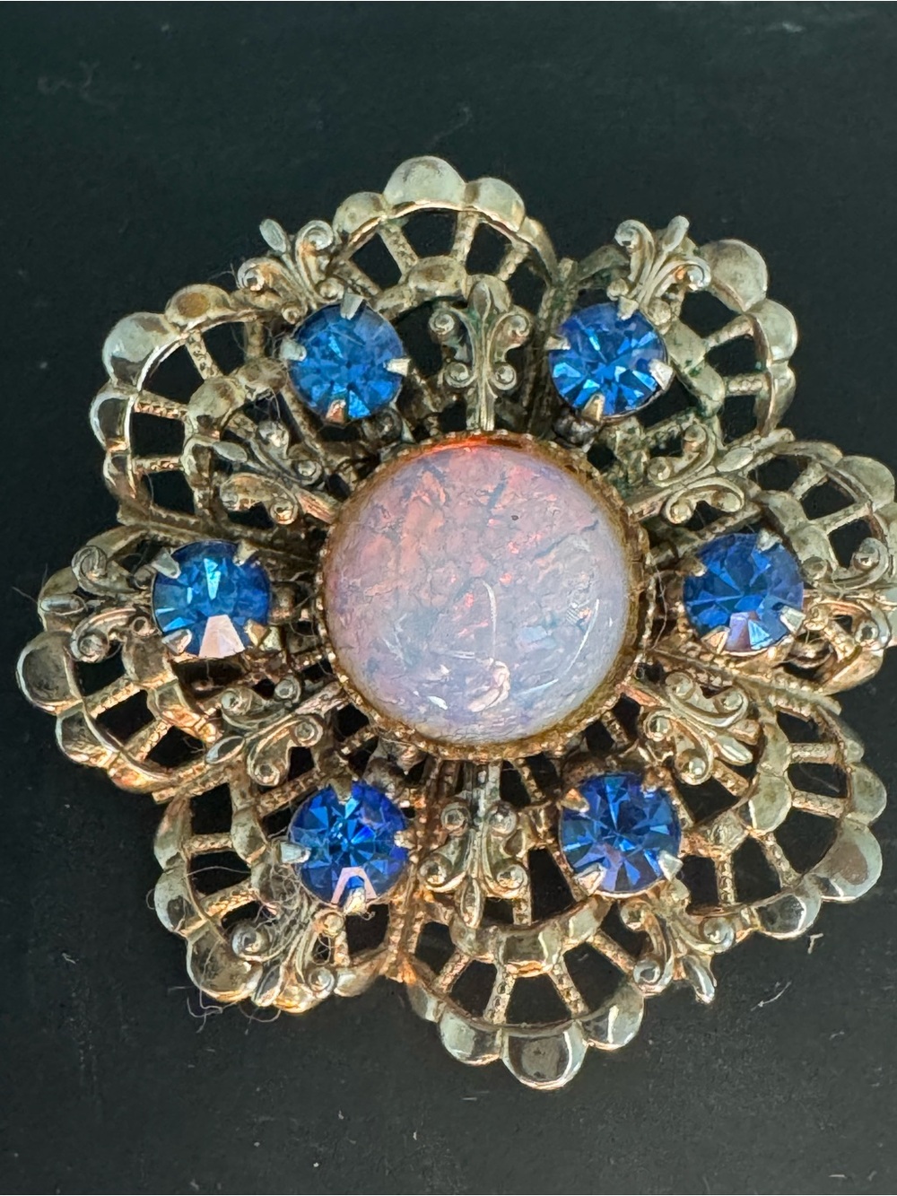Gold-Tone Floral Brooch with Blue Crystal Accents and Iridescent Center